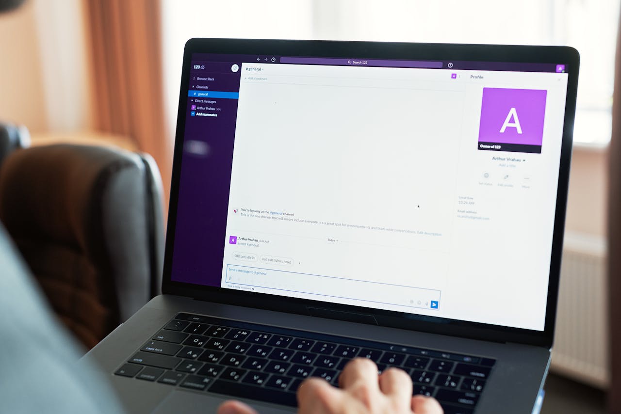 about-us Person using a laptop with an online communication platform, showcasing modern work tech.